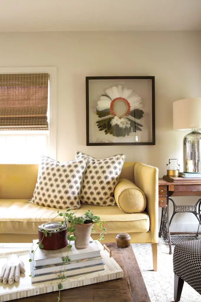 In the family room, Mela & Roam pillows and a framed Brazilian Rikbaktsa tribal headpiece.