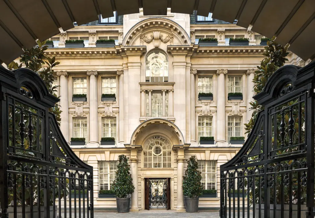 Wrought-iron gates open to the courtyard at Rosewood London.
