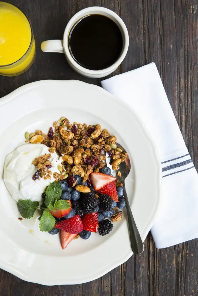 A morning treat — Greek yogurt topped with homemade granola and fresh berries. 