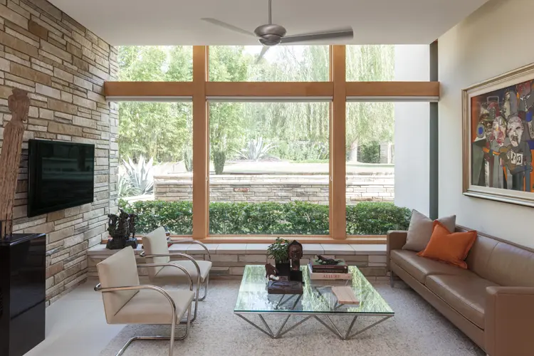 Andersen® E-Series picture windows with pine interiors help this Glen Cove home embrace the outdoors, 