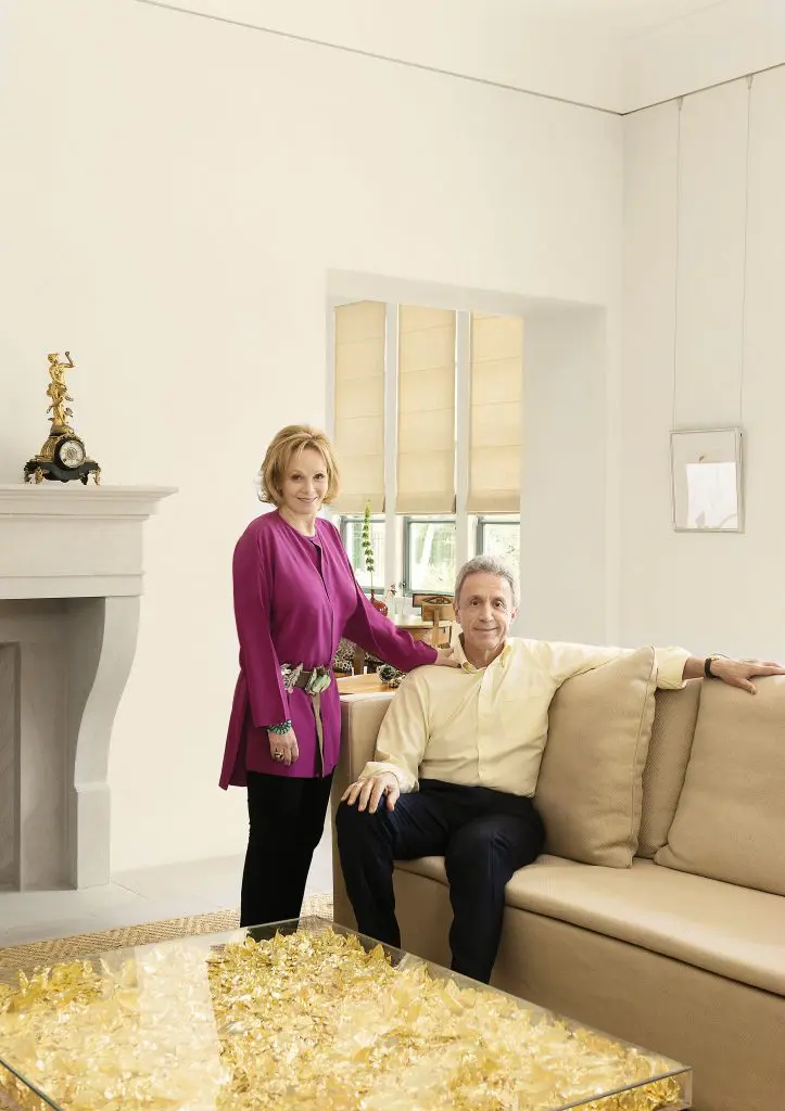 The Kramers in the living room of the villa designed by Walter Murphy and Kirby Mears of Murphy Mears Architects. The room’s defining piece, the coffee table filled with crumpled gold leaf, was designed by Yves Klein; it was a find during Art Basel Miami Beach. They had admired it in a New York Times article but were deterred by the cost; when they saw it in person during the fair, it was a different story. “It was so beautiful,
Steve bought it on the spot. Well, he did bargain a little …” Lauren says.