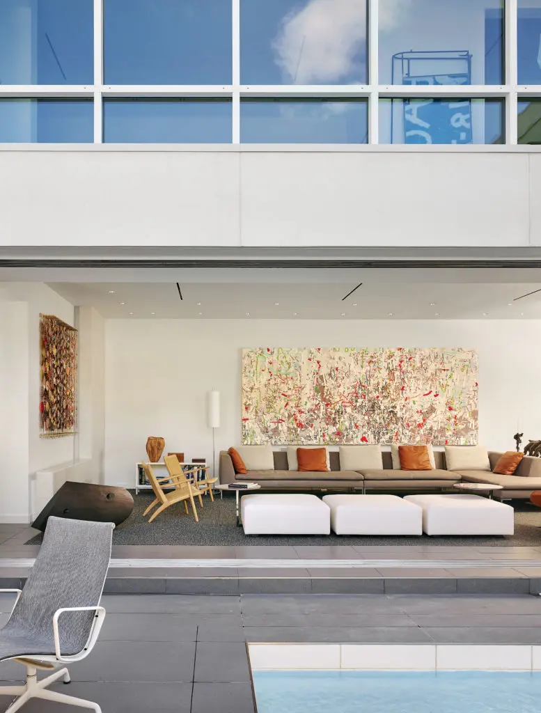 The living room, as seen from the courtyard, with sliding doors open. B&B Italia sofa and Minotti ottomans, all from
Internum. Vintage 1950s Hans Wegner armchairs. Over the sofa, Amy Ellingson’s "Variation (accumulation)," 2013, a
commission. The sculpture is Steve Murphy’s "Untitled," 2011.