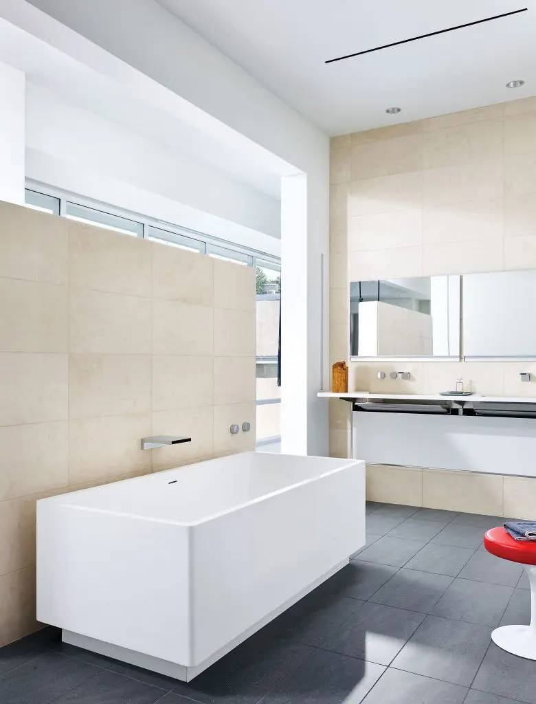 In the master bath, a resin tub by Blu Bathworks, Vancouver, and Caesarstone sink with hidden pipes from Australia. Dornbracht fixtures.