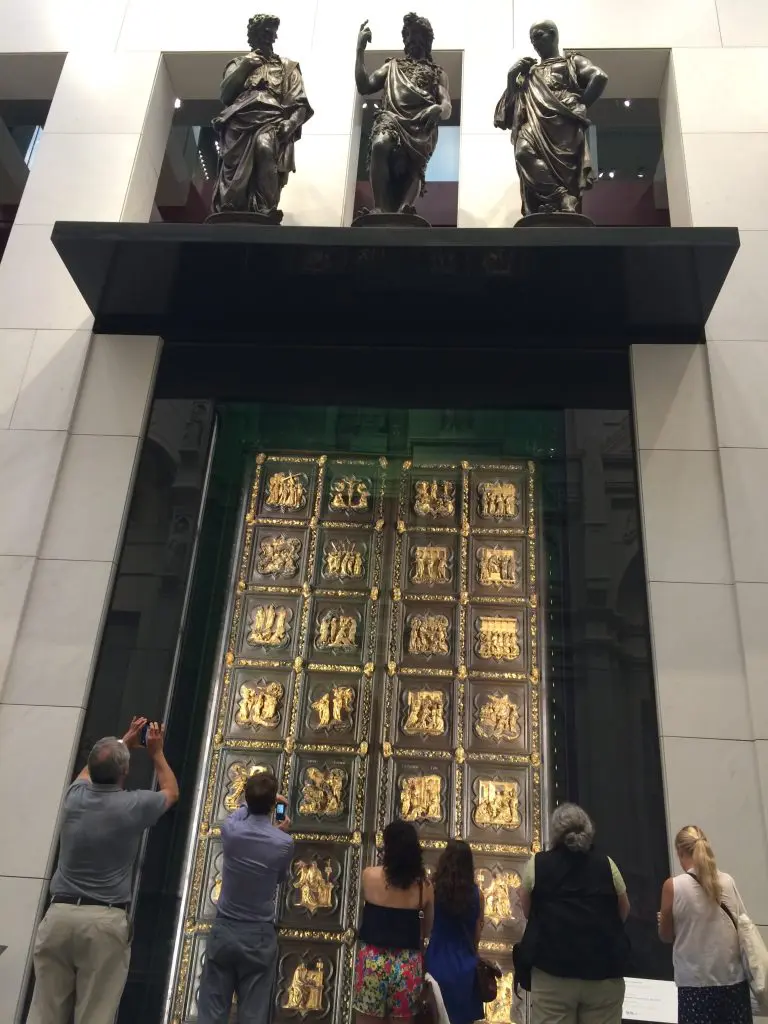 Tourists photograph Ghiberti's original Door of Paradise in the Duomo Museum.
