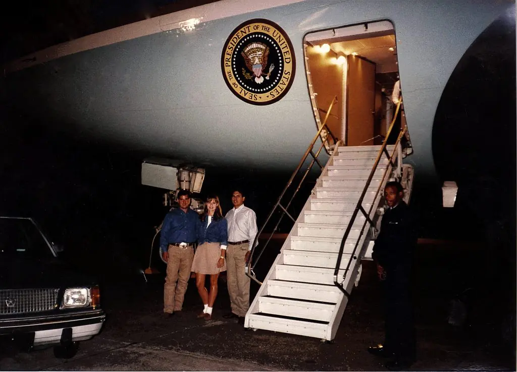 Roberto, Erica, and Raul Molina stand in front of Air Force One. 