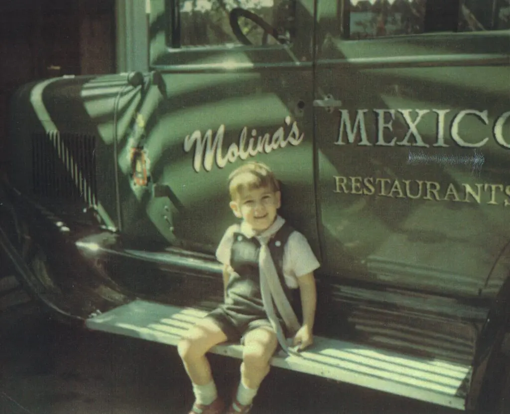 Roberto Molina sits with the Molina's truck. 