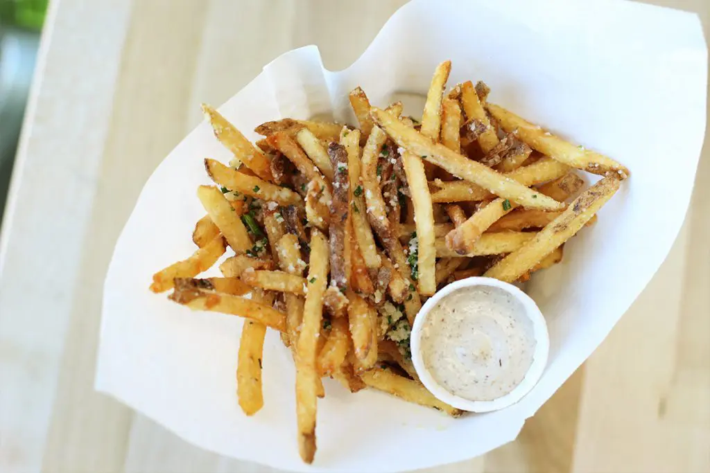 No Hopdoddy burger is complete without parmesan truffle fries. Fries topped with green chile queso and chili con queso are also available. 