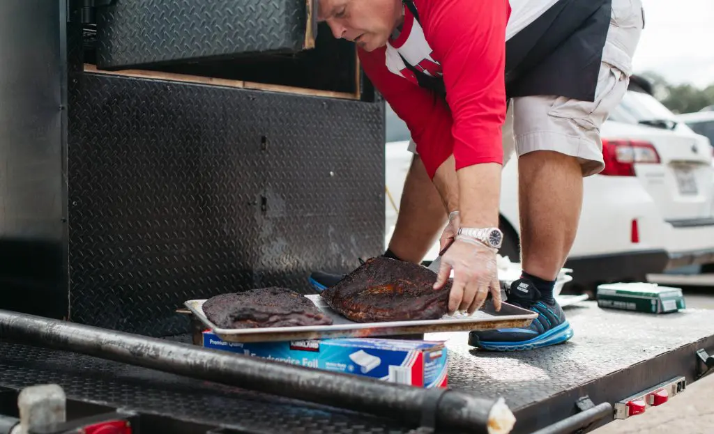 Barbecue king Ronnie Killen loads meat into the portable smoker. 