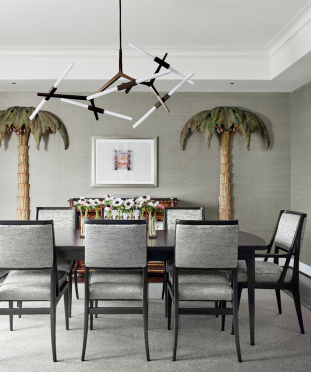 In the dining room, Singer & Sons table and chairs, attributed to Gio Ponti and Bertha Schaefer. Lindsey Adelman Studio light fixture. Artwork Marilyn Baum. Vintage palm-tree floor lamps by Maison Jansen.