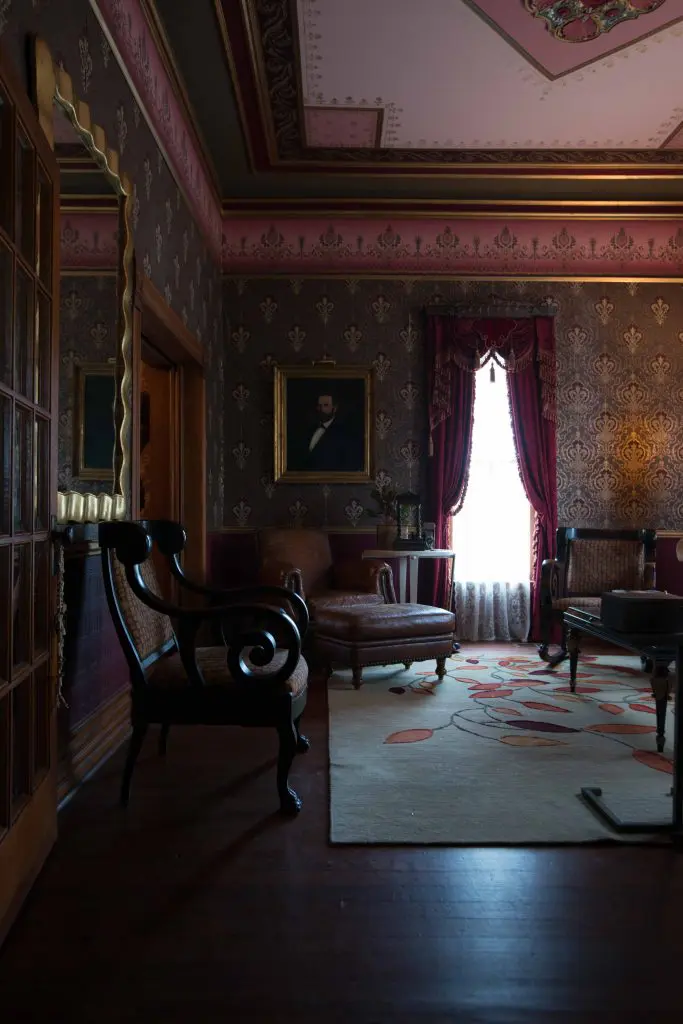 Front-parlor ceiling is hand-painted. Crocodile-leather-print club chair from David Sutherland. Rosemary Hallgarten rug. Antique painting is a flea-market find.