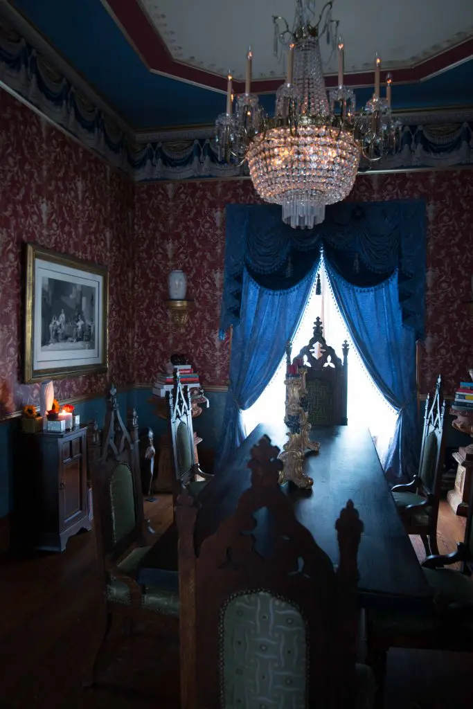 Dining-room chandelier from a Dallas estate. Period American Gothic chairs in Donghia fabric. Antique table was a flea-market find. Gustav Carroll candlesticks.