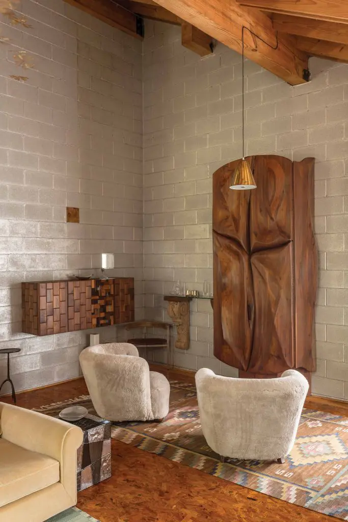 Greatest hits from the mid-20th century onward: Paul Evans Argente cube, chairs by a Danish cabinet maker, Paavo Tynell hanging light, Marta Maas-Fjetterstrom carpet, and Phillip Lloyd Powell bar and wall-mounted cabinet.