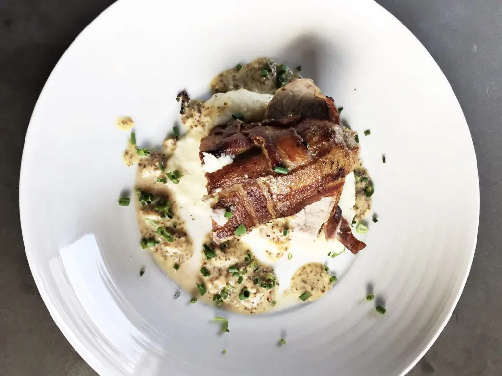 Field & Tides' pork loin is wrapped in bacon and served with mash and creamy IPA mustard. (Photo by Tiffany Halik) 