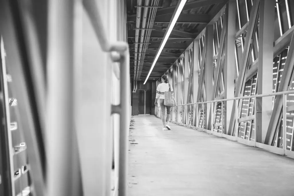 Bridget Kuhns walks over the bridge to the Wortham Theater.