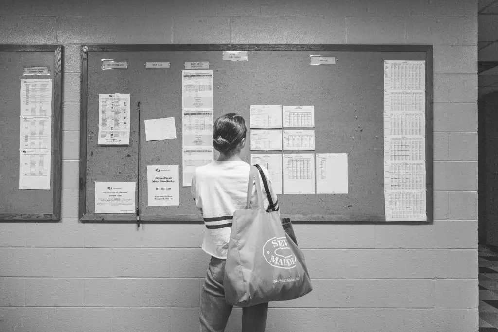 Bridget Kuhns looks at the call board before heading into rehearsals.