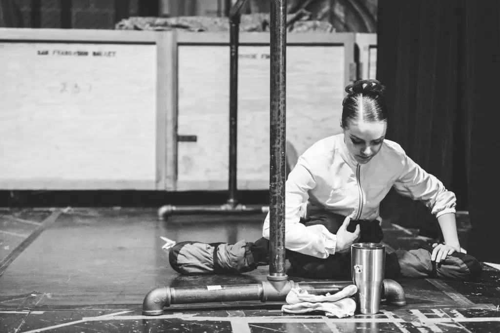 Dressed in warm-up garb, Kuhns stretches backstage. 