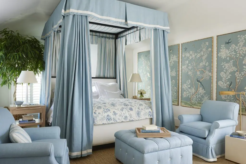 Pacific Palisades king upholstered canopy
bed, Santa Monica open nightstand, San
Remo chair, Canon tufted storage ottoman,
and parchment trays, all Mark D. Sikes for
Henredon