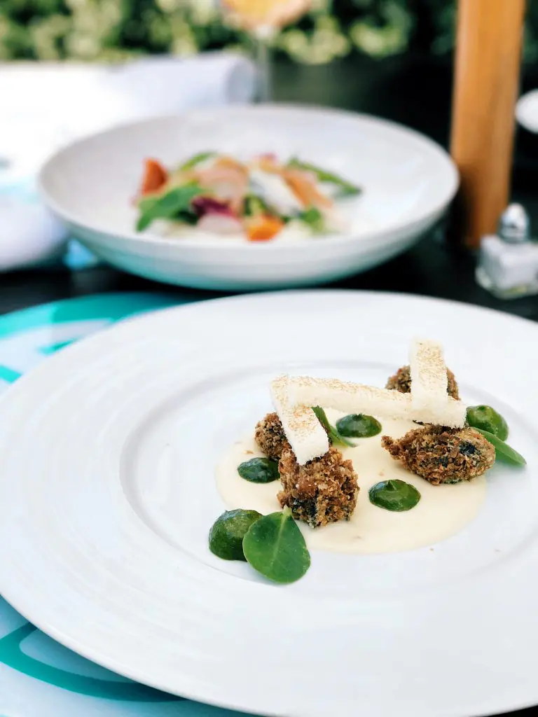 Cafe Azur's escargot dish includes fried snails, garlic cream, and parsley puree. 