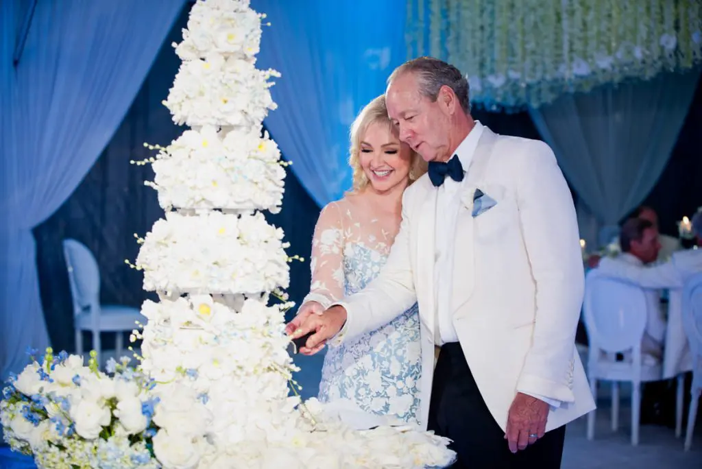 Jim Crane and Whitney Wheeler cut their towering wedding cake.