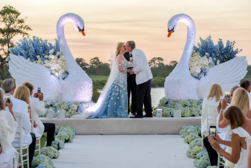 Jim Crane and Whitney Wheeler seal their marriage with a kiss.