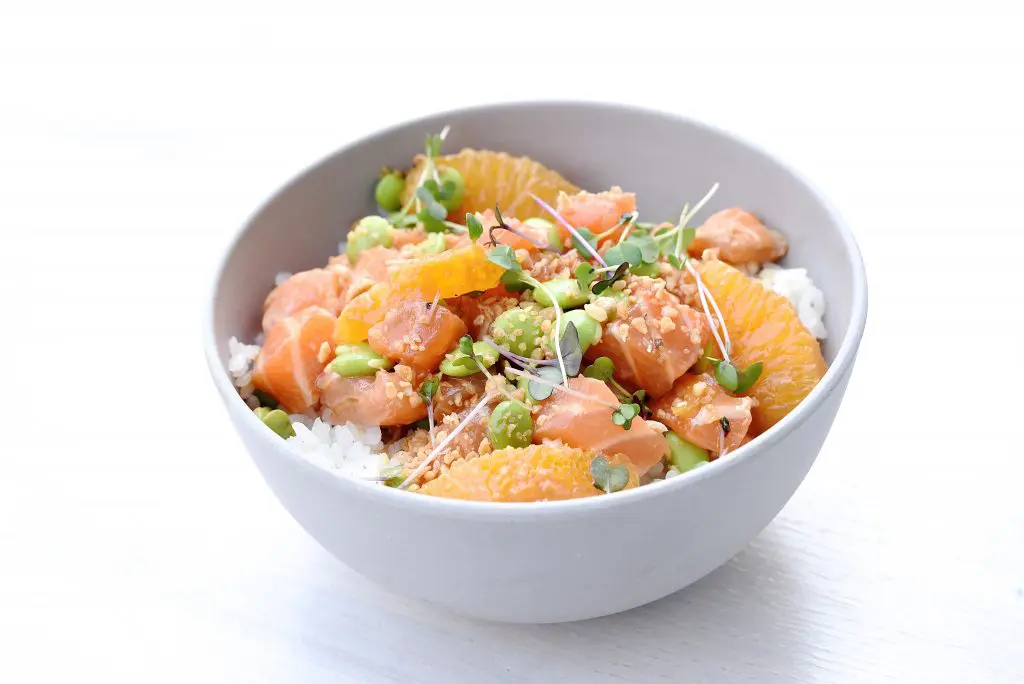 The salmon ponzu bowl at Seaside Poke is dressed with ponzu, orange, edamame, and garlic. 