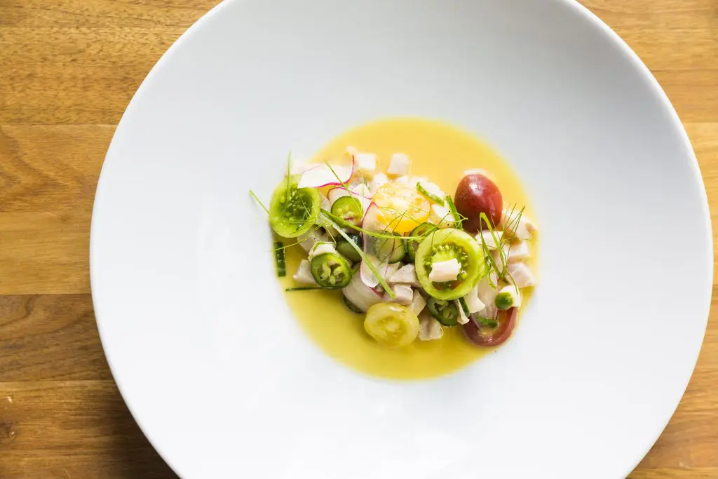 Underbelly's Cobia Ceviche, fashioned with corn milk pickle, tomatoes, and chiles