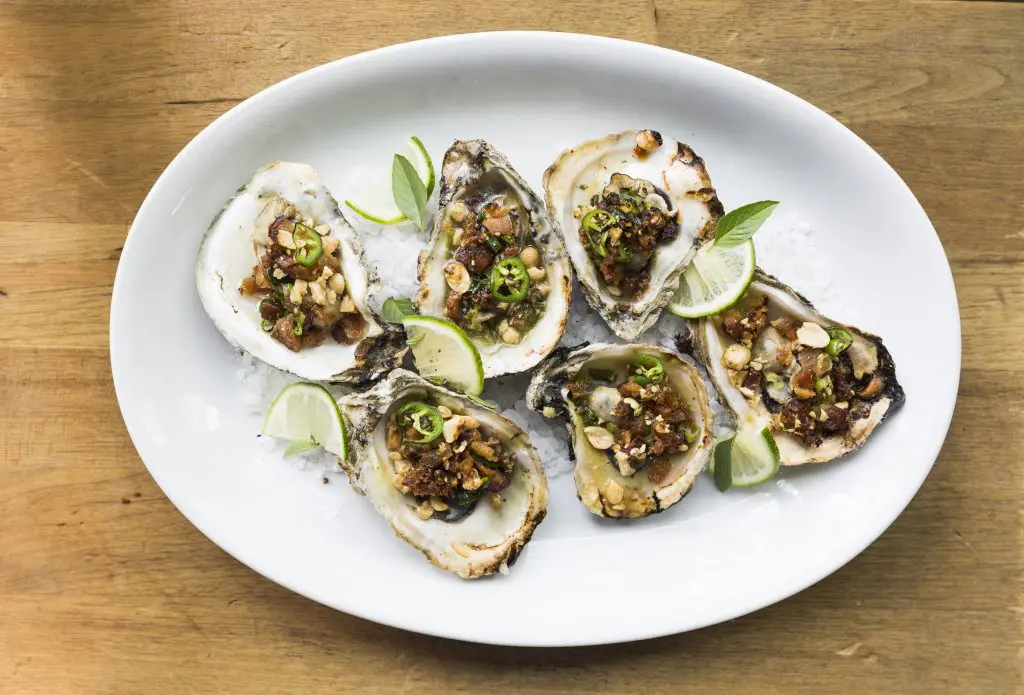 Underbelly's grilled Texas oysters raise the bar with pork belly, peanuts, and green onion. 