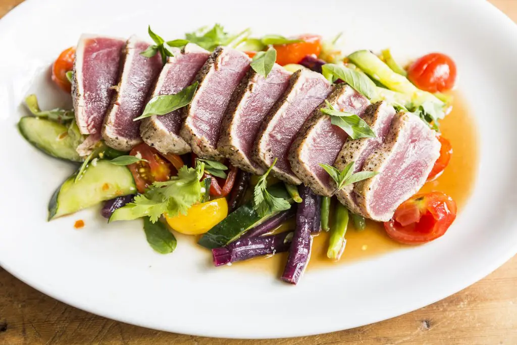 Seared tuna served with Thai-style cucumber, tomato and long bean salad