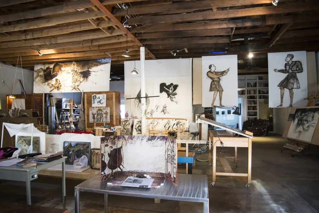 The building across from 100 West was originally a grocery store from 1924 built by L.T. Davis, the founder of Wolf Chili, which got its start in Corsicana. It is now used as the studio for Nancy Rebal and a writer's retreat for her husband, essayist David Searcy.