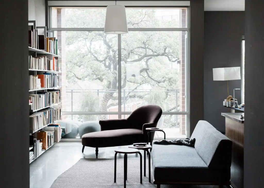 In the library/living room, a George Nelson daybed by Herman Miller, Napoleon III méridienne covered in brown velvet, custom aluminum bookcases by Modern Shelving, and Marcel Wanders for Moooi lamp. Middleton moved into the Mirabeau B., a sustainable apartment building developed by Joey Romano, in the summer of 2014, after living at the modernist Parc IV on Montrose Boulevard during the beginning years of developing his book.