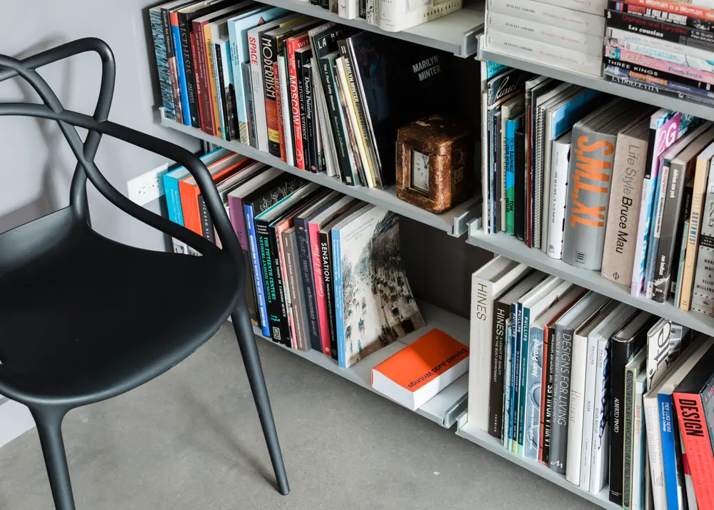 Close-up of the custom Modern Shelving bookcases, and a Starck Masters chair from Kartell. The author’s working library boasts 3,000 books — “moving into the apartment required 35 book boxes,” he recalls. 