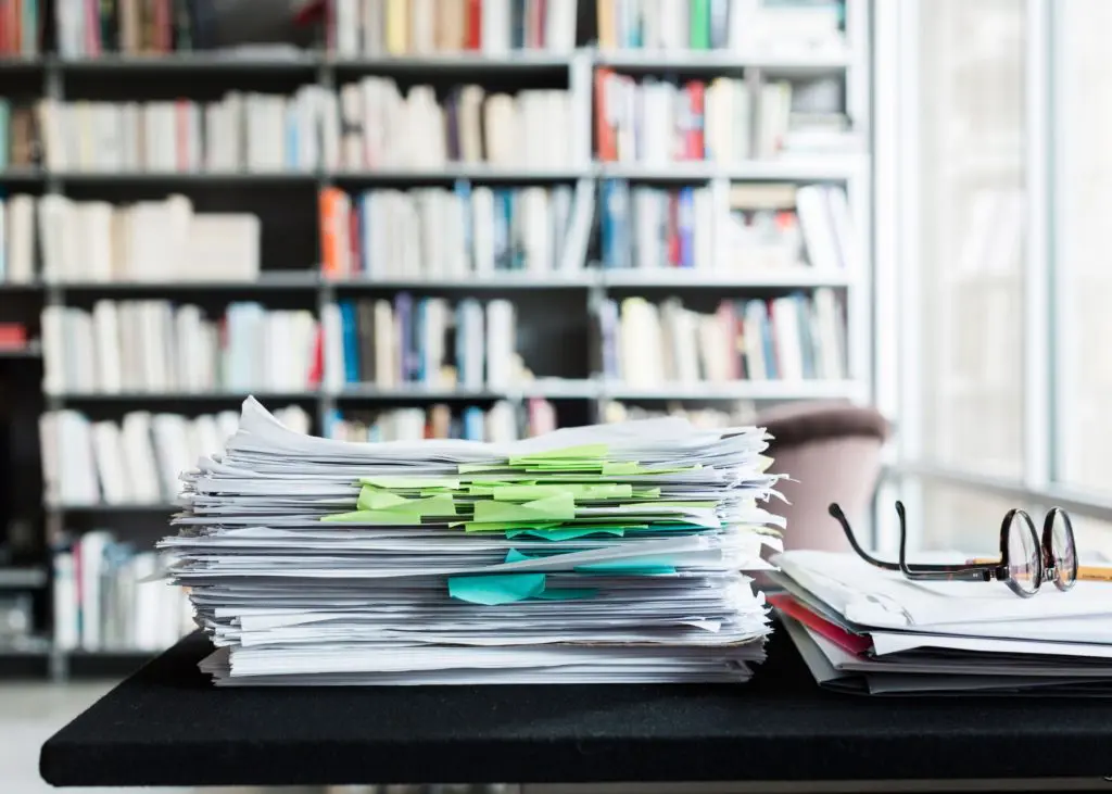 After a decade-long journey, the edited manuscript of the de Menil biography rests near its author’s Maison Bonnet glasses. (Photo Max Burkhalter)