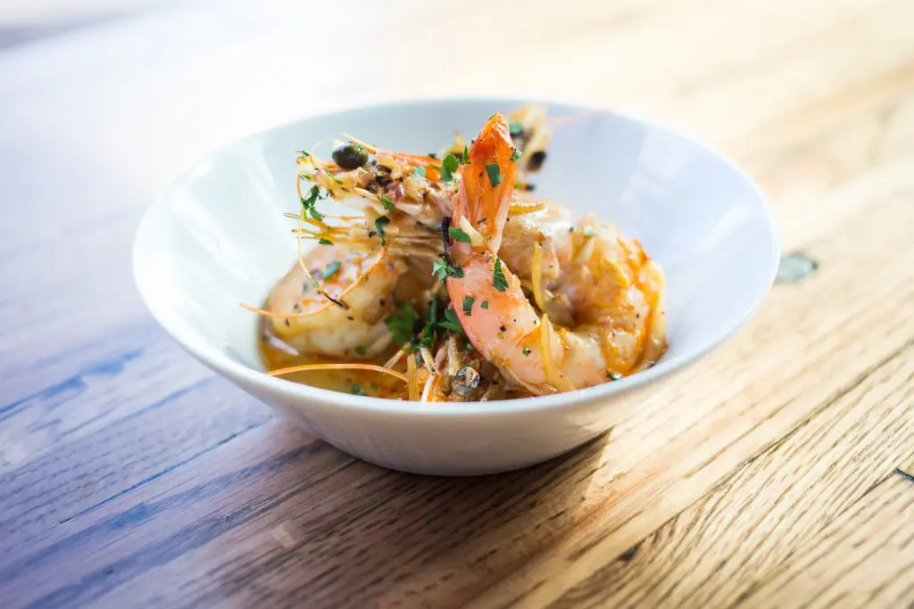 A'Bouzy's Gulf shrimp are enhanced with  garlic butter,
preserved lemon, and capers. 