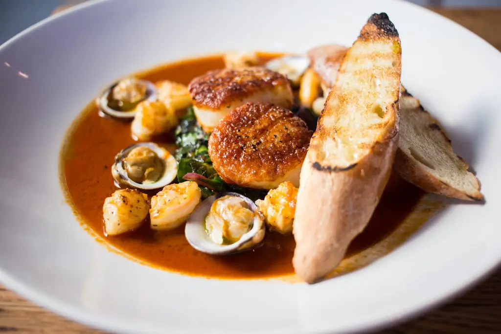 Also on the a'Bouzy menu: seared diver scallops accompanied by braised Swiss chard, seafood broth, and grilled bread. 