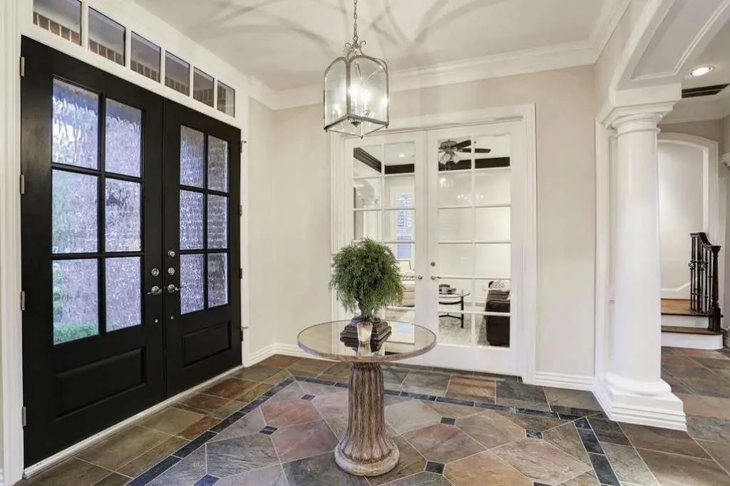 Tom Herman knew he needed a house that could entertain an entire football team. This more modest Bellaire house entryway would no longer do.