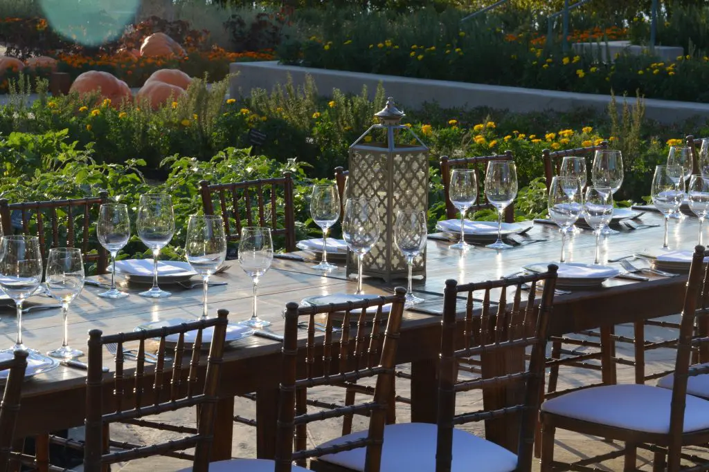 The garden accommodates a long table, perfect for outdoor events.