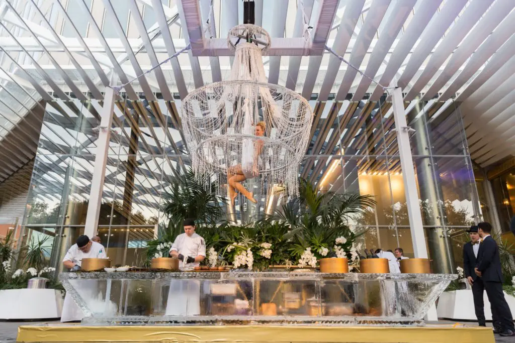 Acrobats took turns serving champagne while dangling upside-down.