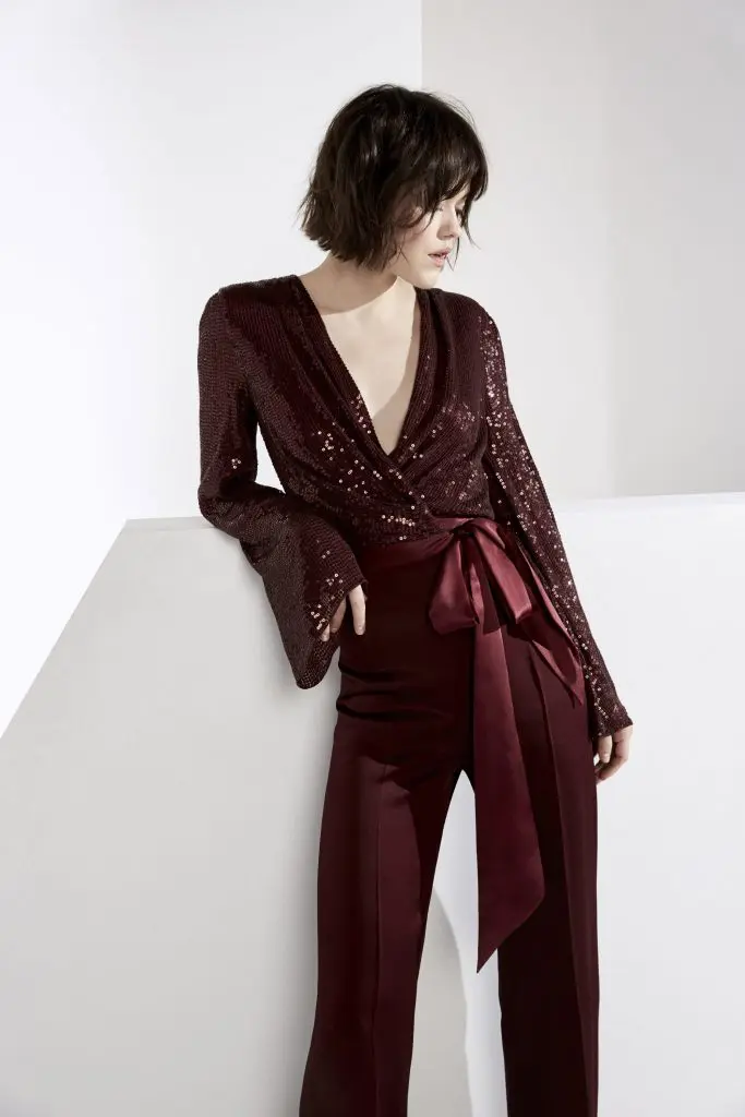 Jenny Packham garnet red sequin wrap top with silk belt and satin crepe palazzo trousers.