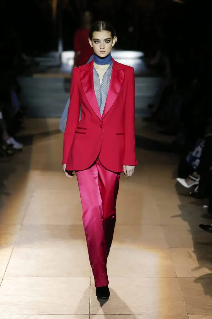 Carolina Herrera red satin jacket and pink slacks.