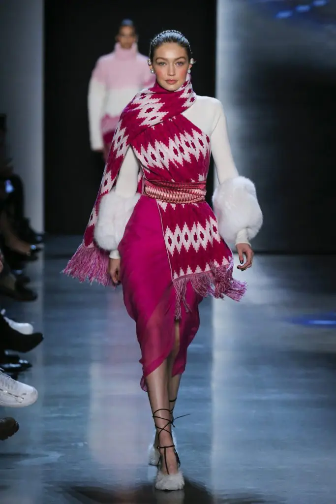 Prabal Gurung porcelain cashmere turtleneck sweater with fox fur trim, orchid silk crepe back satin skirt with silk sarong chiffon draped overlay, orchid multi-engineered mandala stripe wool knit scarf with fringe.