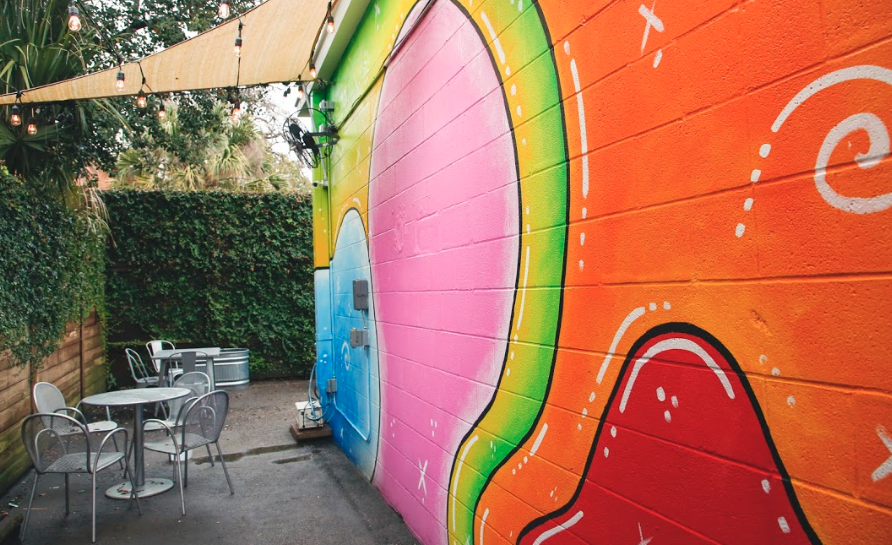 Siphon commissioned a mural to give their patio a Montrose vibe. 