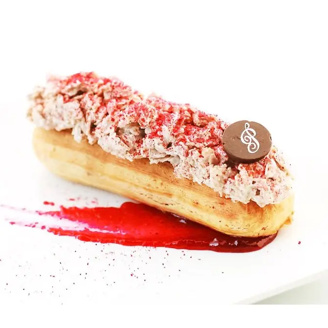 Cafe Poetes specializes in both classic eclairs like this raspberry one and savory options like salmon or brisket. 