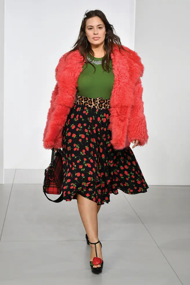 Michael Kors floral skirt, green top, and neon-colored faux fur jacket.