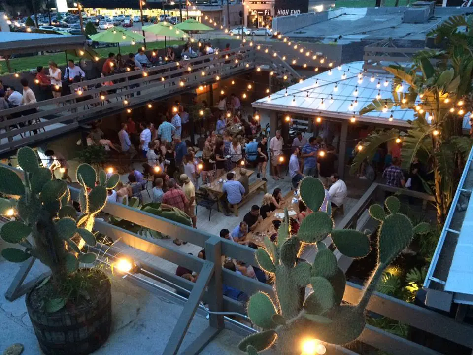 La Grange's vibrant patio features tropical flora and neon umbrellas. (Photo from La Grange's Facebook.)