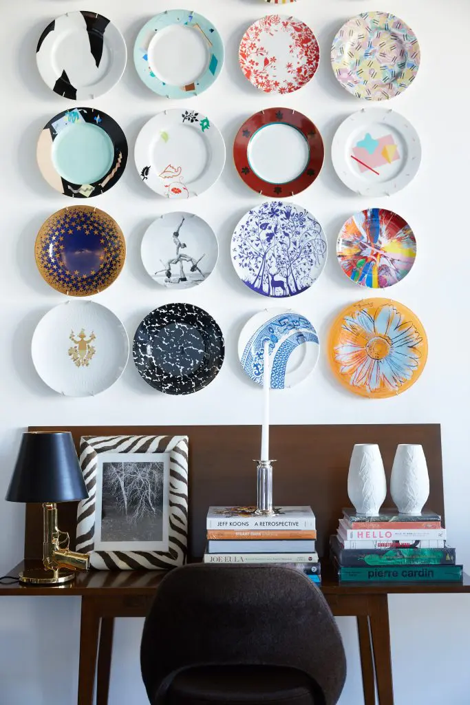 Vintage plates designed by Robert Venturi, Steven Holl,
Ettore Sottsass, Michael Graves, Tord Boontje, Damien Hirst, and Jeff Koons, among others. Edward Wormley folding table from reGeneration, NYC. Philippe Starck Gun lamp for Flos. Tree photograph by Doug Brightwell. Robert A.M. Stern
Century candlestick for Swid Powell. German Heinrich white
bisque leaf vases.