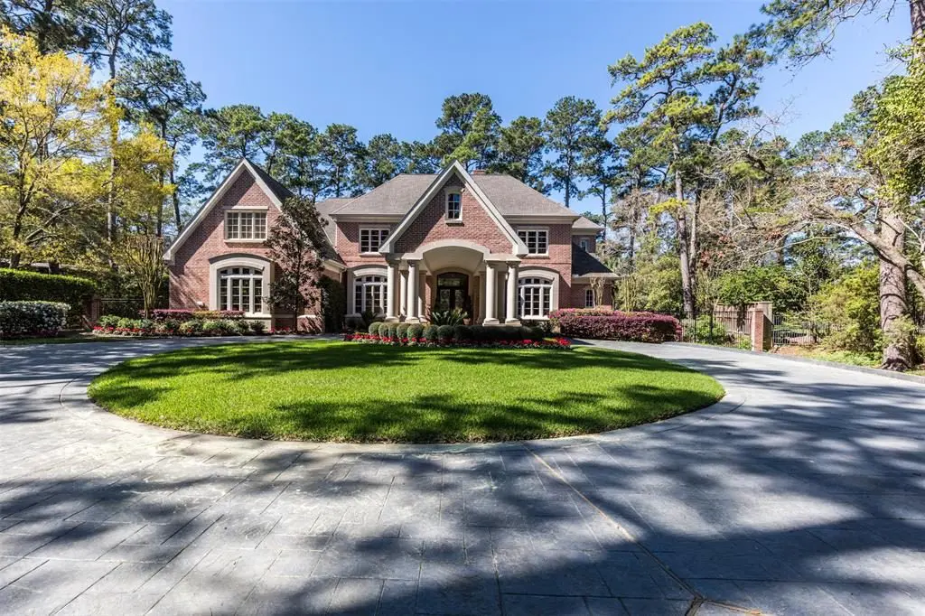 The patterned concrete driveway leads up to the porte cochere. 