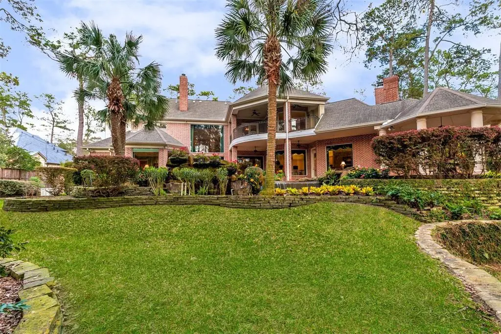 The immaculate backyard has extensive landscaping and stone retaining walls. 