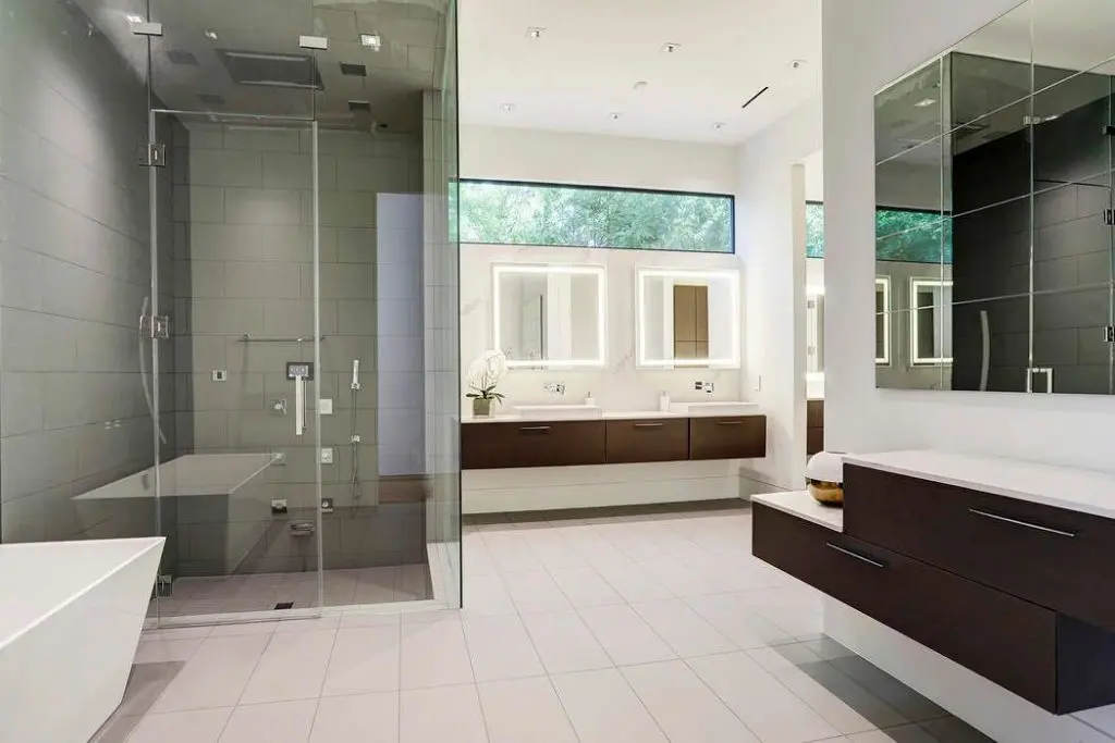 The salon-style vanity and freestanding soaking tub are serene. 