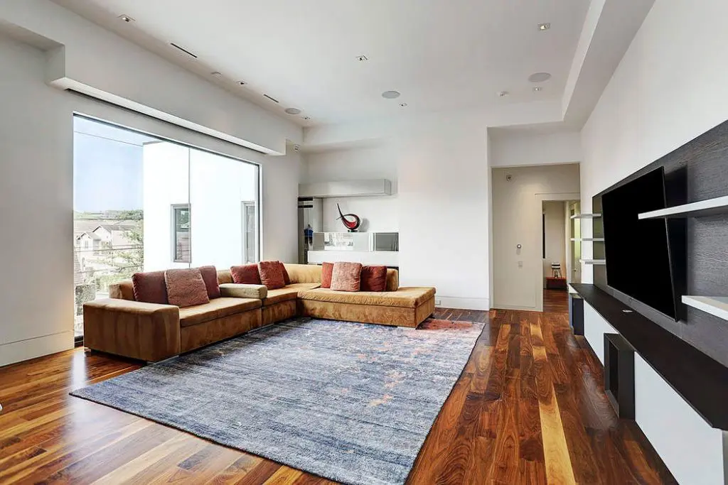 The game room offers a lovely view into the pool from the butted glass window. 