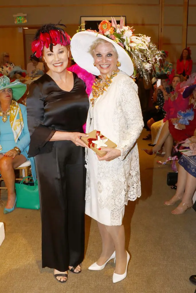 Hat  Judge  Empress  Gilbert  presenting  Peacocks  on  Parade  Best  Botannical  to  Carmaleta  Whiteley  Felton,  co-chair  of  the  2012  Mad  Hatter’s  Tea.